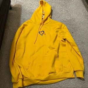 Yellow medium hoodie with a heart design very common never worn